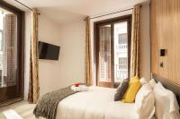 A bed or beds in a room at Apartamentos Day Madrid CHUECA Centro Gran Via Sol Malasaña