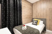 A bed or beds in a room at Apartamentos Day Madrid CHUECA Centro Gran Via Sol Malasaña