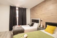 A bed or beds in a room at Apartamentos Day Madrid CHUECA Centro Gran Via Sol Malasaña