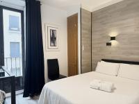 A bed or beds in a room at Apartamentos Day Madrid CHUECA Centro Gran Via Sol Malasaña