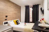 A bed or beds in a room at Apartamentos Day Madrid CHUECA Centro Gran Via Sol Malasaña