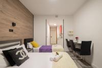 A bed or beds in a room at Apartamentos Day Madrid CHUECA Centro Gran Via Sol Malasaña
