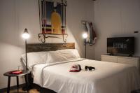 a bedroom with a bed with a hat and shoes on it at room00 Ventura Hostel in Madrid
