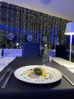 a plate with a piece of cake on a table at Amatì Design Green Hotel in Zola Predosa