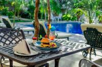 a plate of food on a table near a pool at Kasambabezi Lodge in Victoria Falls