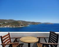 a table and chairs on a balcony with the ocean at Patmos Paradise Hotel in Kámbos
