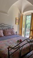 A bed or beds in a room at Appartamento Andora Tra gli ulivi