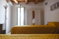 A bed or beds in a room at Casa Vacanze Robinson