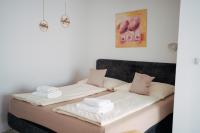 Postel nebo postele na pokoji v ubytování Mikulov Apartmány MAGISTR