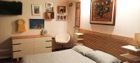 a bedroom with a bed and a desk and a chair at b&amp;b Luna in Siracusa