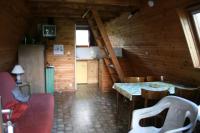 a room with a table and chairs in a cabin at La Ptite Ferme de Caro in Meyrignac-lʼÉglise