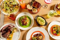 a wooden table with plates of food on it at Renaissance Dallas Hotel in Dallas