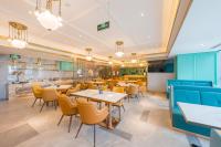 a restaurant with tables and chairs and a kitchen at Atour Hotel Beijing You'anmen West Tieying Subway Station in Beijing