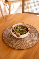 a bowl of food on a plate on a table at Antana Hotel in Canggu
