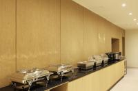 a row of trays on a counter in a restaurant at BrownDot Hotel Hongseong Naepo in Hongseong