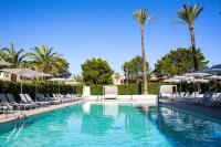 a swimming pool with lounge chairs and palm trees at BQ Sarah -Adults Only in Can Picafort