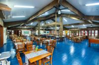 a restaurant with blue floors and wooden tables and chairs at Hotel Fazenda Mato Grosso in Cuiabá