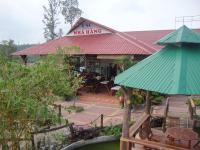 a restaurant with a large green umbrella in front of it at Bình Sơn Hotel - Khách sạn tại Dung Quất in Bình Sơn