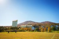 a park with a bench in a field with a city at ANA Crowne Plaza Resort Appi Kogen by IHG in Hachimantai
