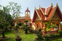 a house with a statue on the front of it at Happy Place Official in Nai Yang Beach