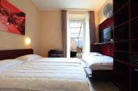 Postel nebo postele na pokoji v ubytování Hotel Elvezia Ascona