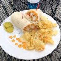 a plate of food with a burrito and potato chips at Deer Creek Winery at Watson Estate in Uniontown