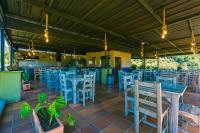 a restaurant with blue tables and chairs at Hotel Bambu Guatape in Guatapé