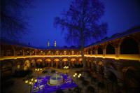 a building with a courtyard at night with lights at Rüstempaşa Kervansaray Hotel in Edirne