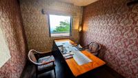 a room with a wooden table and two chairs at 天からの贈り物 VillaMontpetre in Kirishima