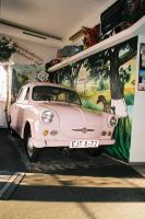 a pink car parked in front of a wall with a painting at Hotel Gasthof Goldener Hahn in Frankfurt Oder