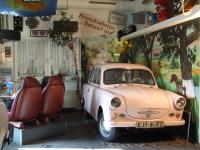 an old car is parked in a garage at Hotel Gasthof Goldener Hahn in Frankfurt Oder
