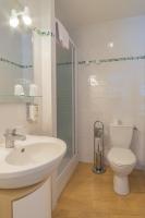 a white bathroom with a sink and a toilet at Manoir Du Parc (Adults only) in Amboise