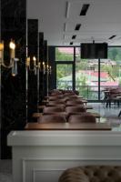 a row of brown chairs lined up in a room at Demederon Hotel in Hamsikoy