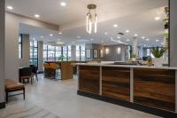 an open kitchen and living room with a island in a house at Holiday Inn & Suites Winnipeg Downtown by IHG in Winnipeg