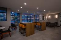 a restaurant with two tables and chairs and windows at Holiday Inn & Suites Winnipeg Downtown by IHG in Winnipeg