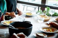 a table with a bowl of soup and plates of food at Lomahostelli in Keuruu