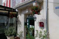 a building with potted plants in front of a door at Hotel Du Commerce in Pont-Saint-Esprit