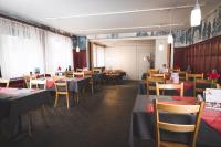 a restaurant with tables and chairs in a room at Gasthof zur Saline in Pratteln