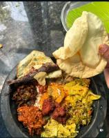 een bord met eten op een tafel met eten bij Lavilla Lake Resort And Restaurant in Kollam