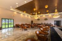 Un gran comedor con mesas y sillas. en Axiom Resorts Luxury Cottages, Arambol, en Arambol