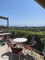 a table and chairs on a patio with a view at Mount View Overnight Accommodation in Penzance