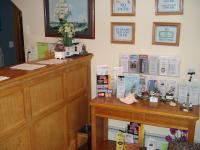 a room with a desk with books on the wall at Atlantic Motel in Point Pleasant Beach