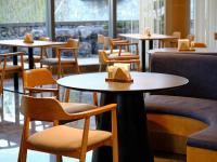 a row of tables and chairs in a restaurant at Ruolinqiao Valley Garden Hotel in Tiantai