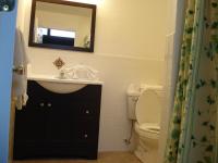 a bathroom with a sink and a toilet and a mirror at Atlantic Motel in Point Pleasant Beach