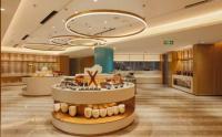 a lobby of a hotel with aasteryasteryasteryasteryasteryasteryasteryasteryastery at Shanghai Sunshine Hotel - Hongqiao Road Subway Station Branch in Shanghai