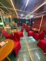 a room with red chairs and tables in a restaurant at Hotel Apa Ammaa Lodge, Restaurant, and Spa in Kathmandu