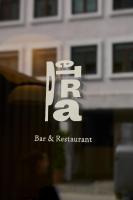 a reflection of a bar and restaurant sign in a window at Hotel Petra in Copenhagen