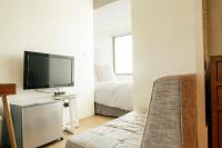 a living room with a couch and a tv at NK Hostel in Taipei