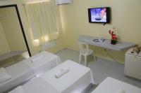 a bathroom with a sink and a table and a mirror at JR Hotel in João Pessoa