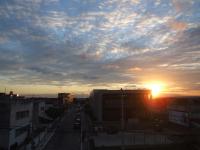a view of a city with the sunset in the sky at JR Hotel in João Pessoa